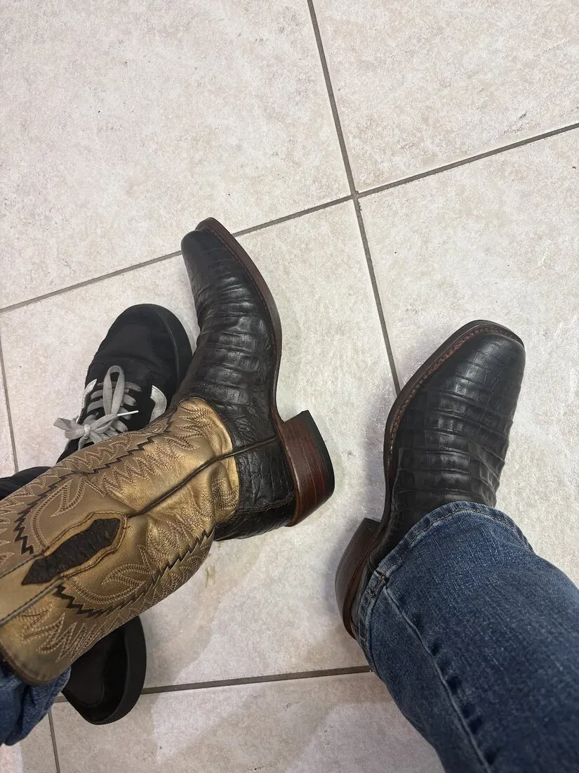 The repaired cowboy boots being worn